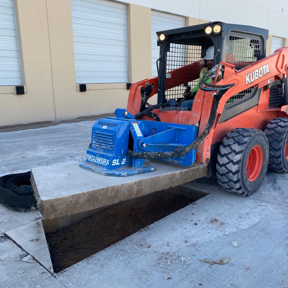 suction machine removing concrete blocks